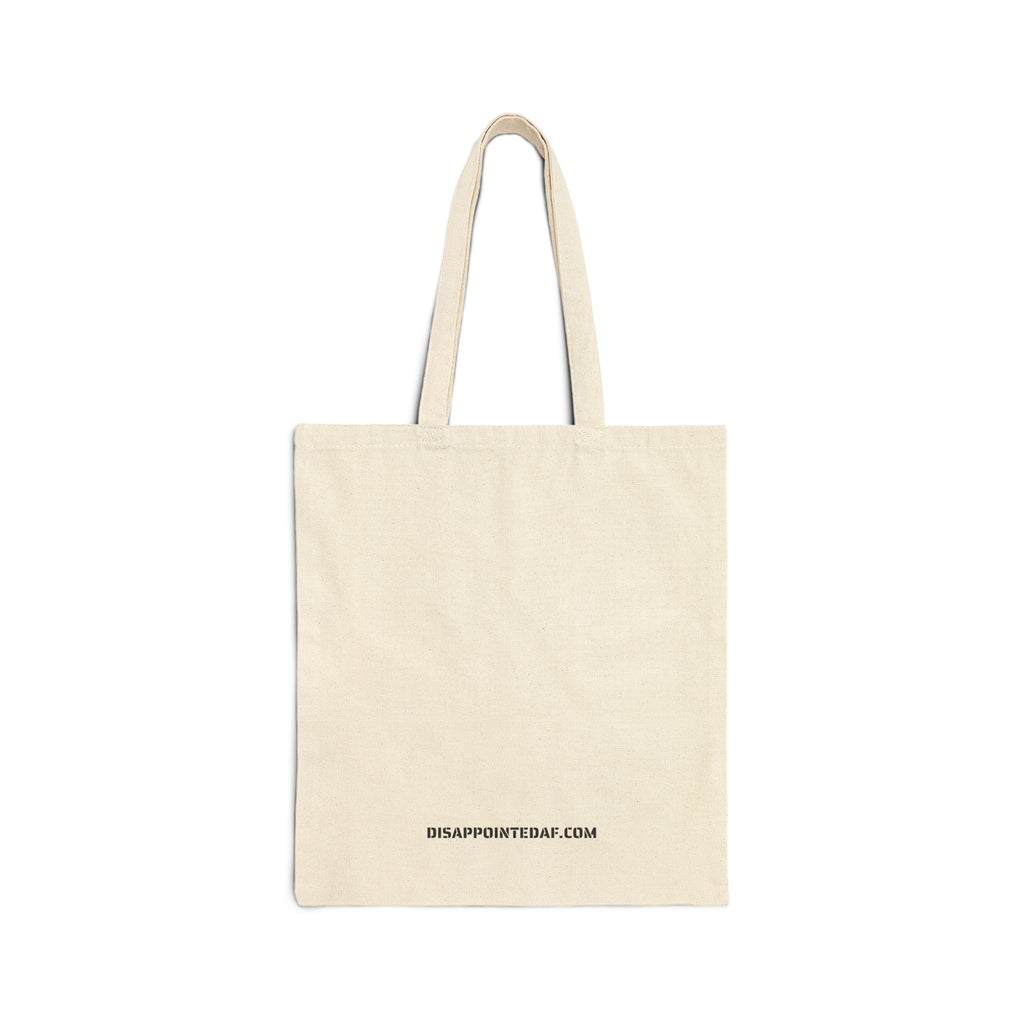 A natural canvas tote bag with two straps and a graphic on a plain white background. At the bottom of the bag, the URL DisappointedAF.com is printed