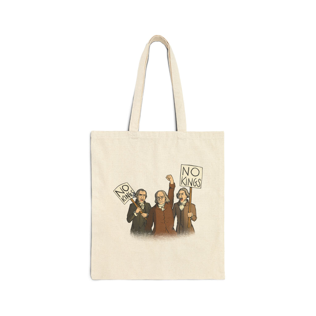 An off-white canvas tote bag with two straps and a graphic on a plain white background. The bag has a printed illustration of three Disappointed American Founders protesting and holding 'NO KINGS' signs.