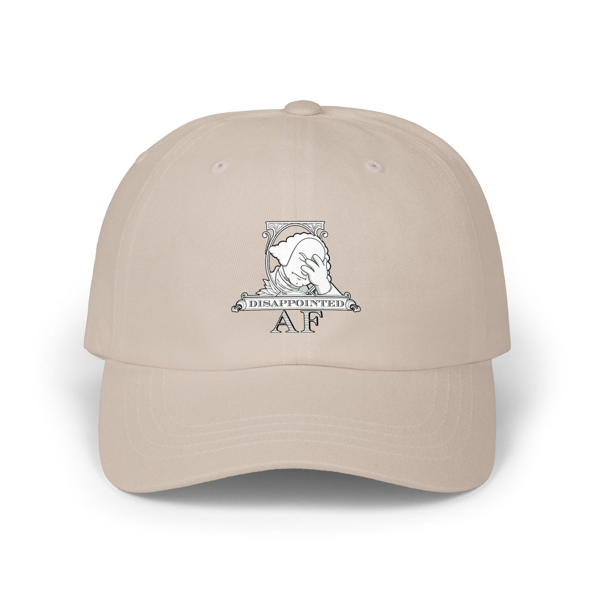 A beige baseball cap with a white graphic on the front depicting Disappointed AF's logo. The logo is framed with scrolls, similar to that of a dollar bill, with George Washington in the center. George Washington looks disappointed and has his head in his hand.