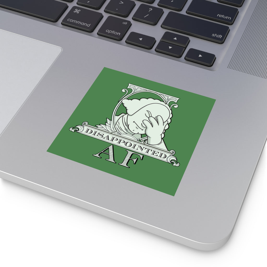 A square political sticker featuring a pale green illustration of the logo for Disappointed AF on a laptop computer. The logo is white on a green background and framed with scrolls, similar to that of the dollar bill. George Washington's bust is in the center looking disappointed, his head leaning forward out of the scrolled framing, with his head in his hand and an exasperated look on his face. Below the figure it says Disappointed AF.